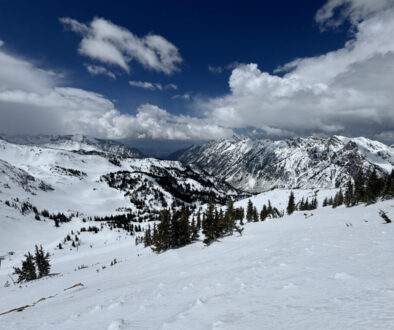 Snowy ski slopes with the Salt Lake Valley in the background, seen from the top of Snowbird